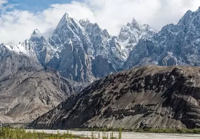 Majestic Karakoram Peaks: Snow-Kissed Giants and Serene River