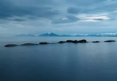 Serene Winter Seascape: Snow-Capped Mountains and Calm Waters