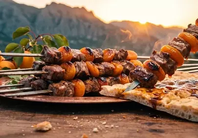Golden Hour Feast: Succulent Kebabs & Mountain Sunset