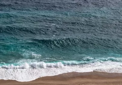 Serene Ocean Waves Embrace Golden Sands