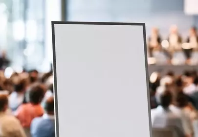 Dynamic Meeting Backdrop: Blank Sign Amidst Engaged Audience