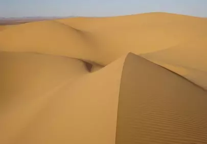 Stunning Sahara: Ochre Sand Dunes in a Vast Desert Landscape