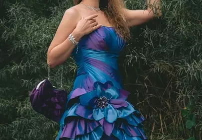 Stunning Elegance: Woman in Purple Evening Gown Amidst Nature's Embrace