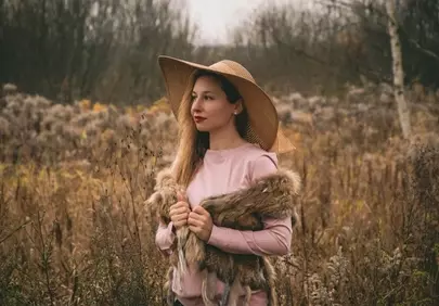 Enchanting Autumn Portrait: Woman in Hat Amidst Golden Fields