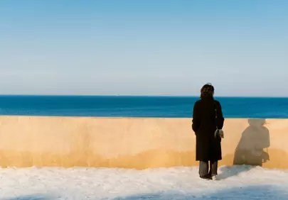 Serene Seascape: Woman Gazing at the Horizon