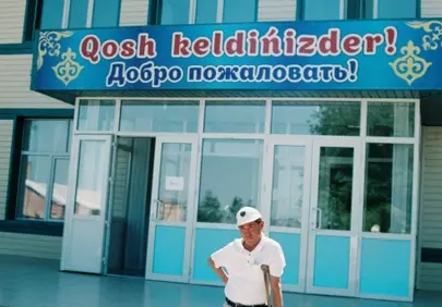Resilient Spirit: Elderly Man with Crutches Outside a Building