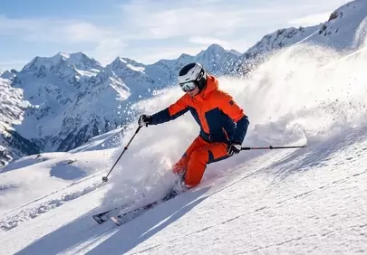 Epic Alpine Descent: Skier Carving Through Fresh Powder