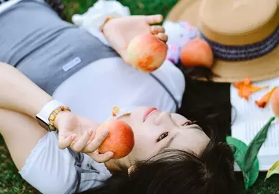 Serene Summer Escape: Woman Relaxing with Peaches in Nature