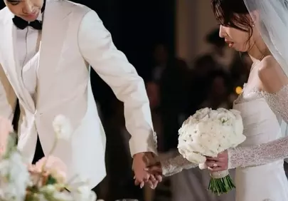 Elegant Wedding Moment: Bride and Groom Hand in Hand