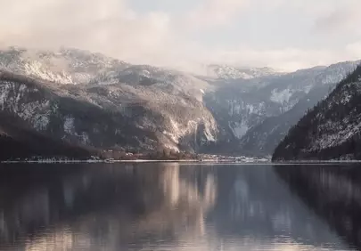 Winter Serenity: Snow-Capped Mountains Reflected in Tranquil Lake