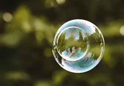 Enchanting Rainbow Bubble Floating in Green Serenity