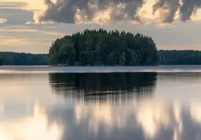 Serene Sunset Reflection: Tranquil Finnish Lake Landscape