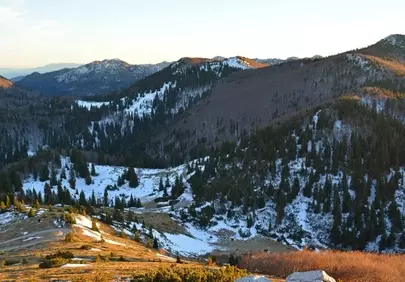 Dramatic Winter Sunset Bathes Velebit's Snowy Peaks in Golden Light