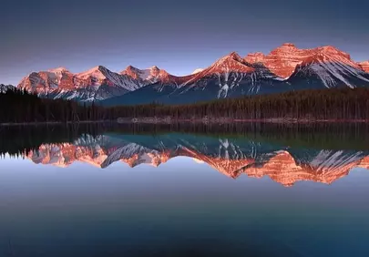 Breathtaking Alpenglow: Herbert Lake's Mirrored Mountain Majesty