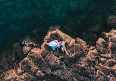 Breathtaking Drone View: Romantic Couple on Rocky Beach