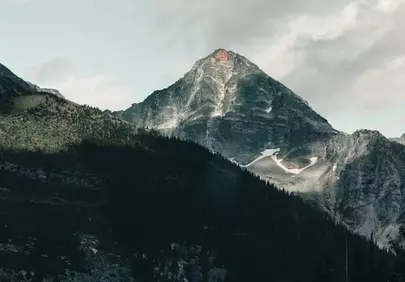 Majestic Mountain Peak Embracing Whispers of Sunlight