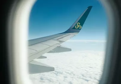 Breathtaking Flight: Wing View Above Serene Clouds