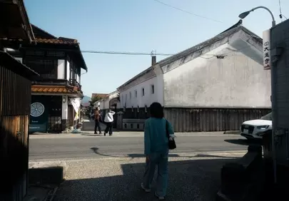 Historic Town Stroll: Woman Explores Ancient Japanese Streets