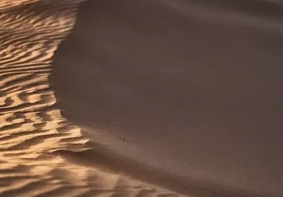 Golden Hour Desert Serenity: Undulating Sand Dunes at Sunset