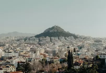 Breathtaking Cityscape: Woman Overlooking Mountain Metropolis