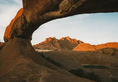 Breathtaking Desert Arch: Golden Sunset over Ancient Peaks