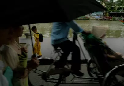 Vibrant Yellow Amidst Rainy Riverside Hustle