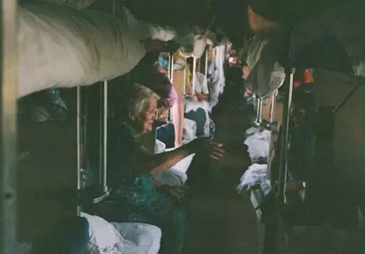Timeless Journey: Elder Woman in a Bustling Train Car