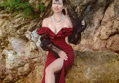 Enchanting Gothic Queen: Red Dress Elegance on a Tropical Beach