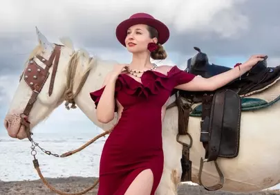 Elegant Lady in Red with White Horse on Beach