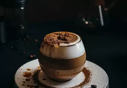 Artistic Espresso: Foamy Coffee Elegance with Cocoa Dust