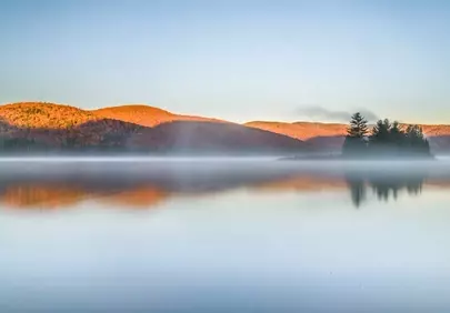 Misty Autumn Dawn: Serene Canadian Lake Reflection
