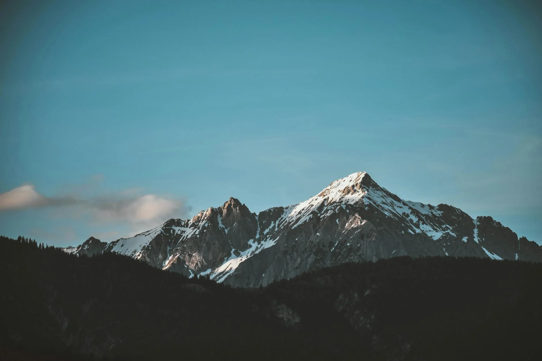 Majestic Snow-Capped Peaks Against a Clear Blue Sky