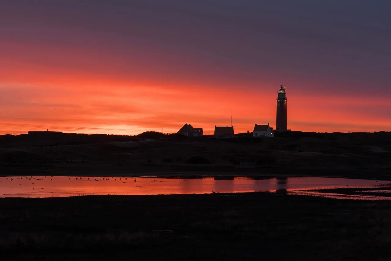 Dramatic Texel Sunset: Lighthouse Silhouette Against Fiery Sky