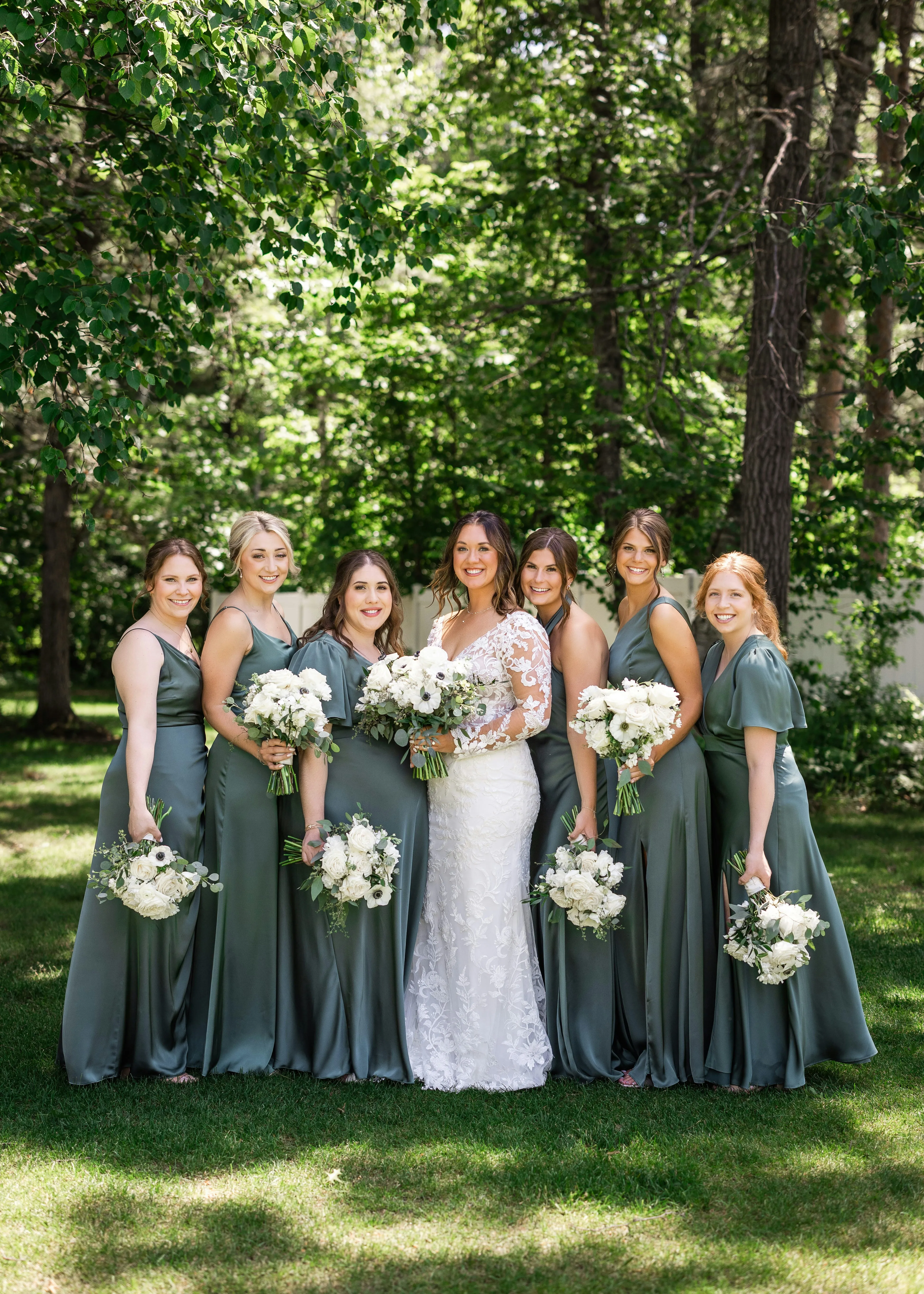 Stunning Bride and Bridesmaids in Sage Green Amidst Lush Garden
