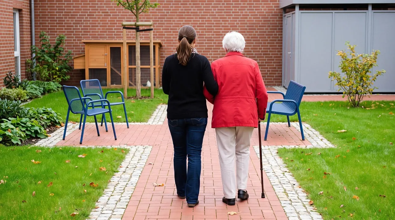 Heartwarming Autumn Stroll: Caregiver and Elderly Companion in Garden