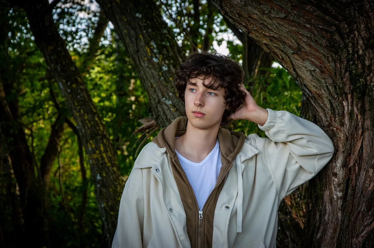 Enigmatic Youth: Sunlight Whispers in Nature's Embrace