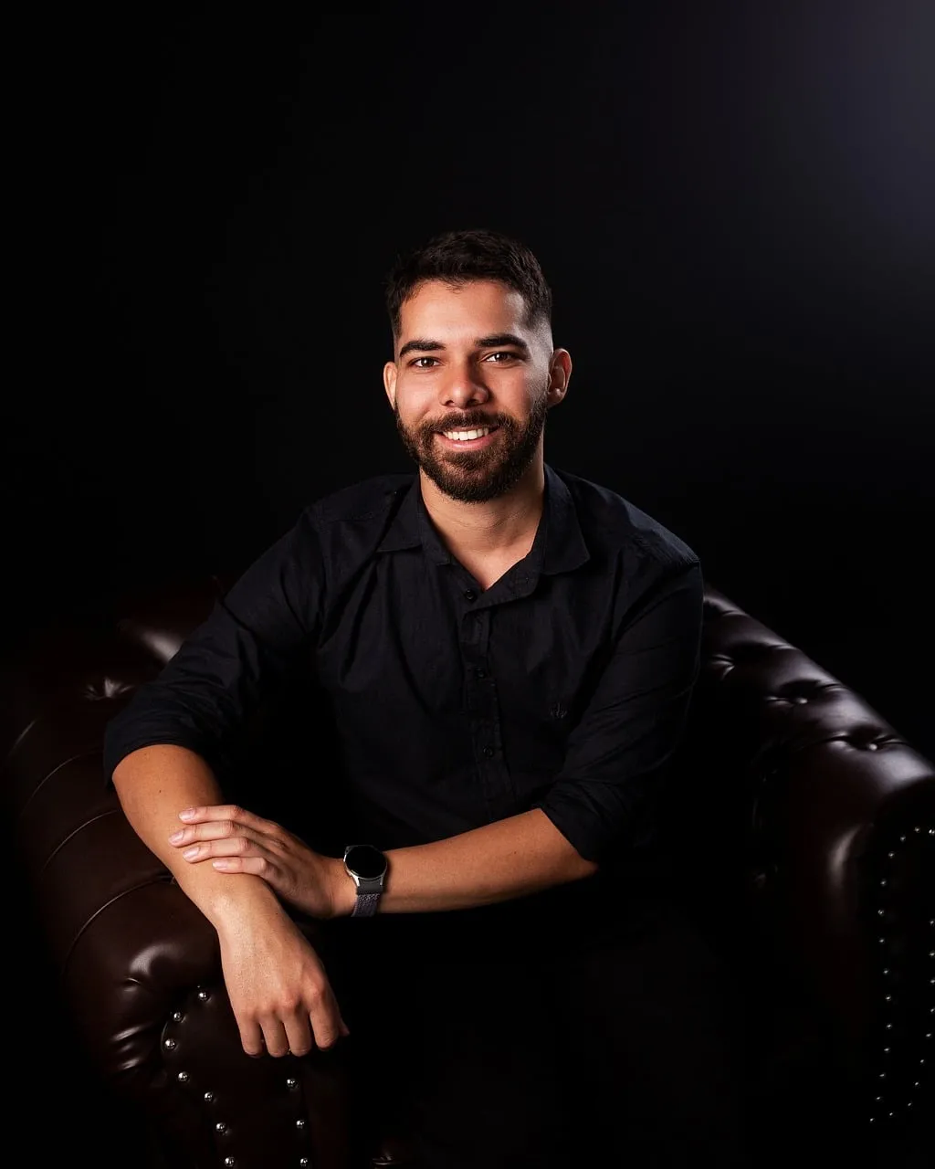 Charming Gentleman Grinning on a Luxurious Leather Sofa