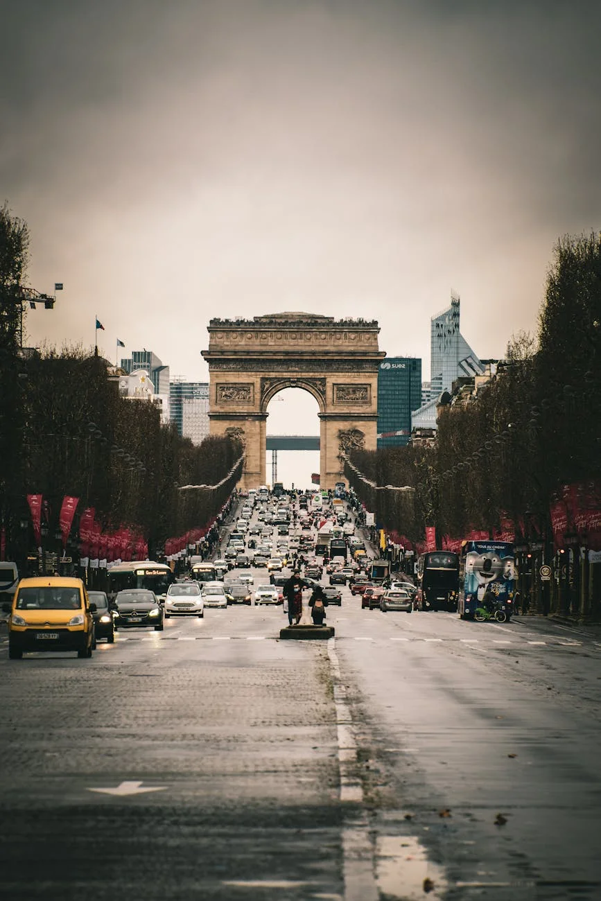 Iconic Parisian Grandeur: Arc de Triomphe Amidst City Bustle