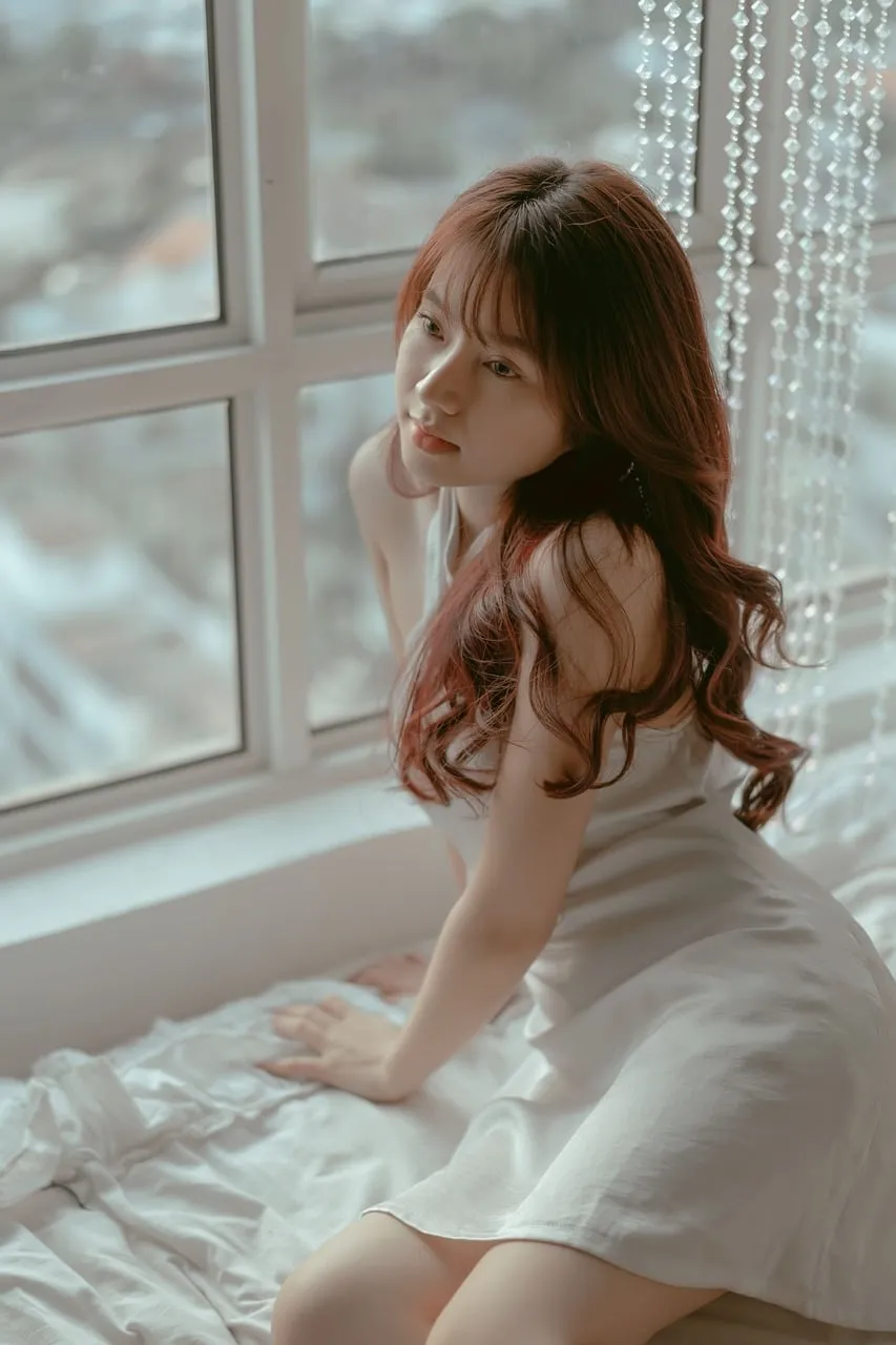 Dreamy Serenity: Young Woman by the Window in Natural Light