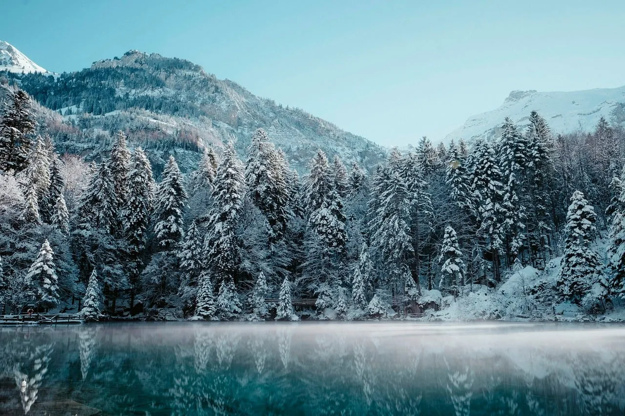 Breathtaking Winter Wonderland: Snowy Mountains & Serene Lake Reflection
