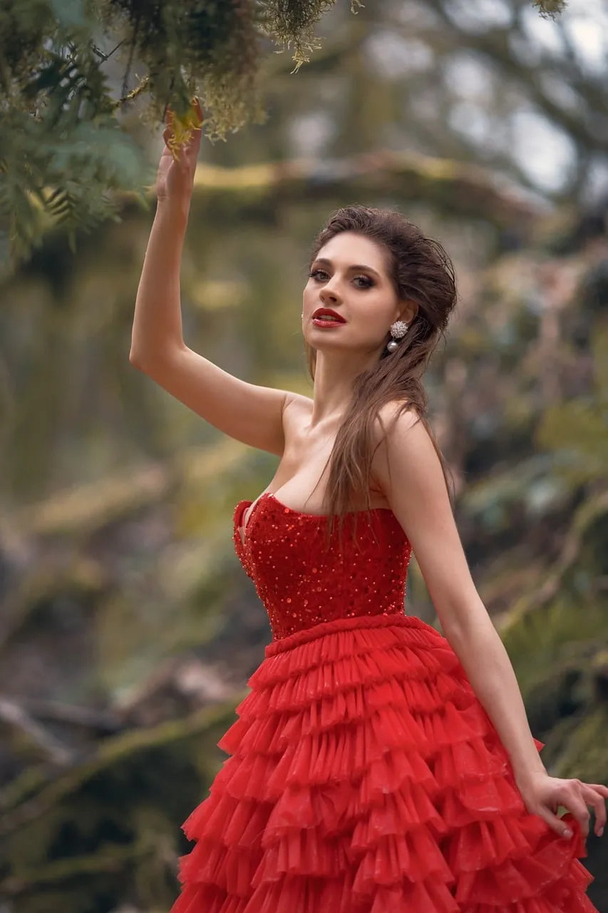 Enchanting Forest Queen: Woman in Red Gown Amidst Nature's Embrace