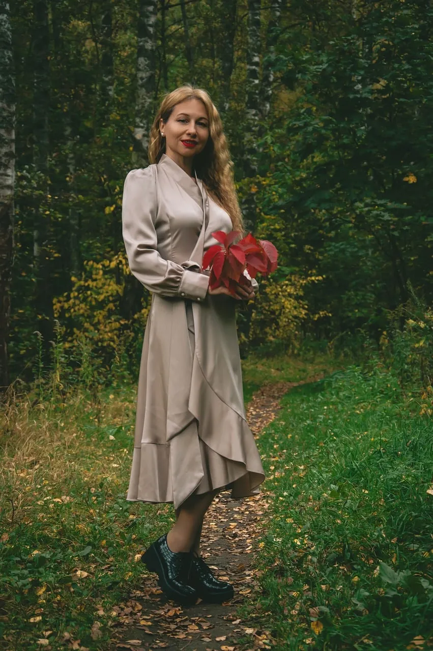 Enchanting Autumn Elegance: Woman Embraces Forest Beauty