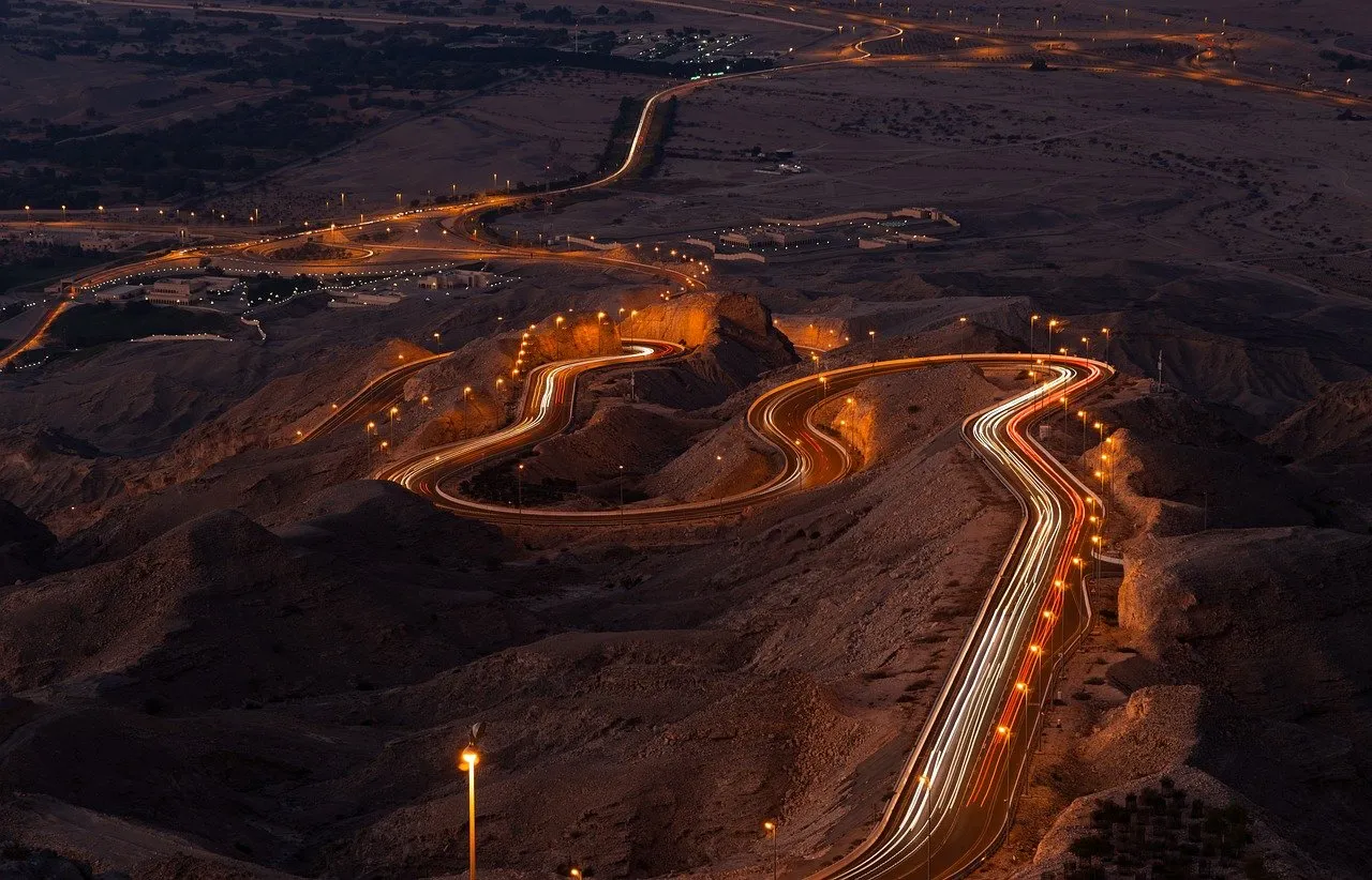 Breathtaking Night Drive: Winding Mountain Road Illuminated by Traffic