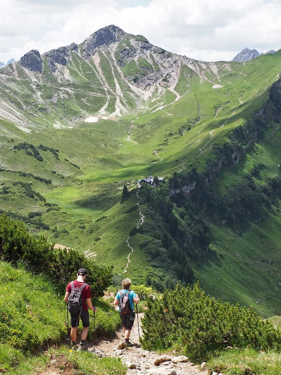 Breathtaking Alpine Panorama: Hikers on a Summer Mountain Trail