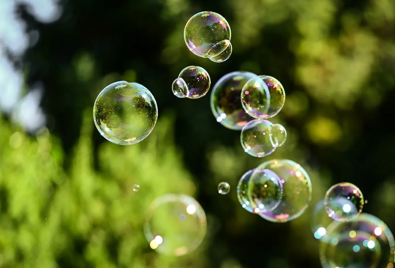Enchanting Iridescent Bubbles Floating in Nature's Green Embrace