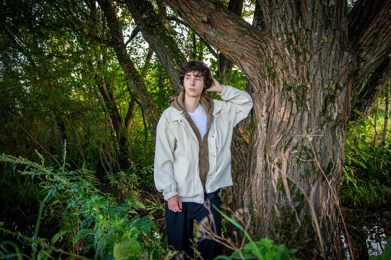 Serene Forest Escape: Young Man's Contemplative Summer Retreat