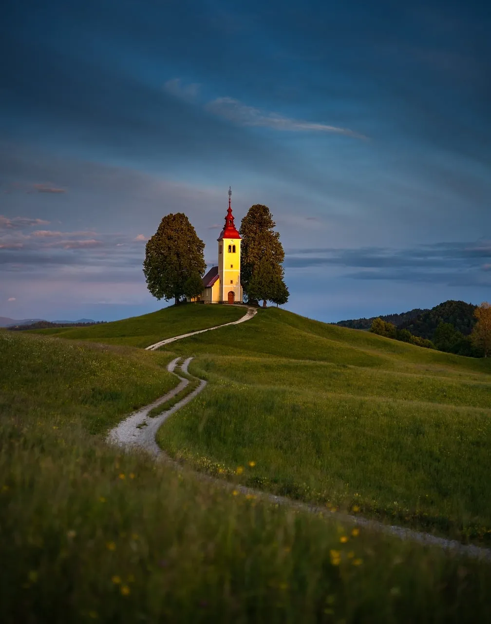 Enchanting Slovenian Church Bathed in Sunset's Golden Glow