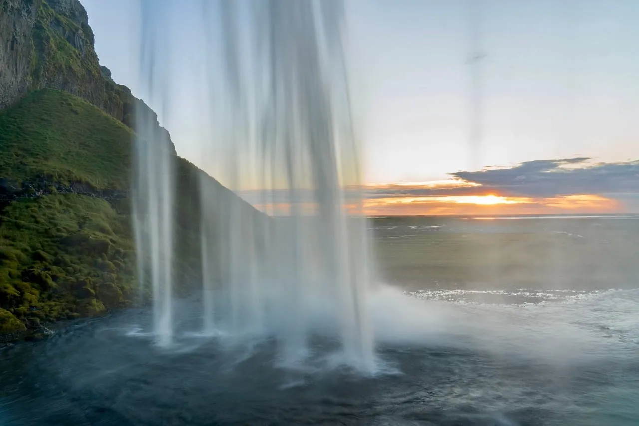 Dramatic Iceland Waterfall Sunset with Golden Hues