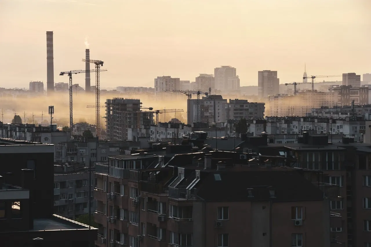 Hazy Urban Dawn: Industrial Cityscape at Sunrise