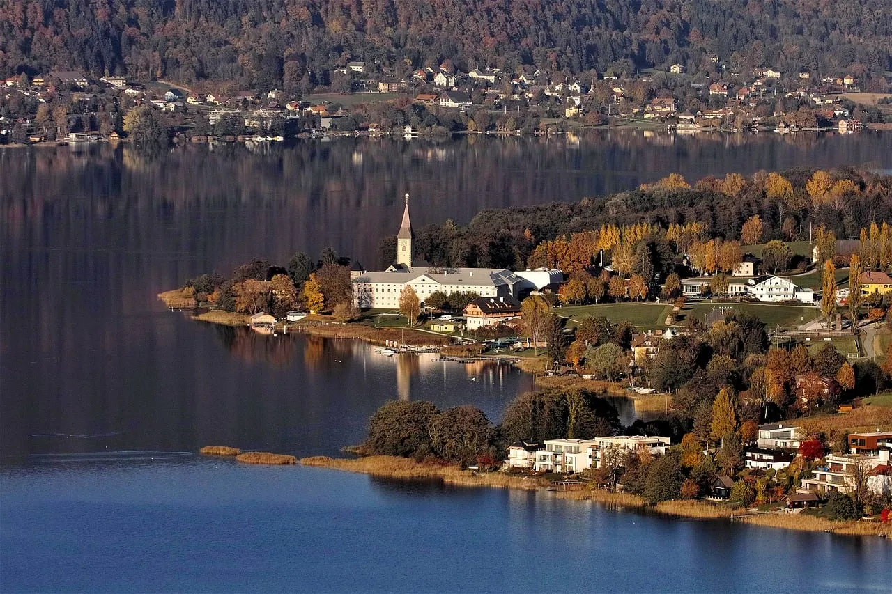 Serene Autumn Lake Reflections: Idyllic Alpine Village Charm